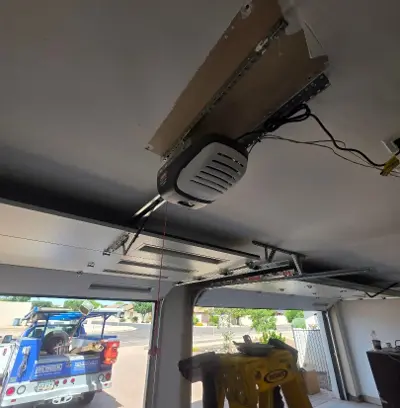 After — Dual Garage Door Installation with Genie Openers and Glass Panels