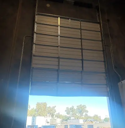 Before — Commercial Roll-Up Door Repair after Forklift Impact