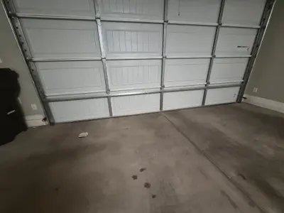 Before — Storm-Damaged Bottom Panel Repair for Sectional Garage Door