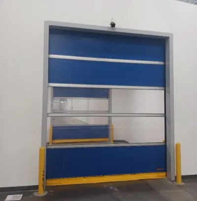 High-speed door with blue panels partially open