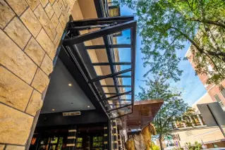 Hydraulic glass door raised at a restaurant entrance