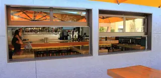 Glass doors open at a bar service window