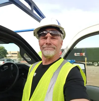 Professional technician in safety gear at commercial job site