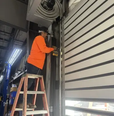 Technicians at work on garage door installation
