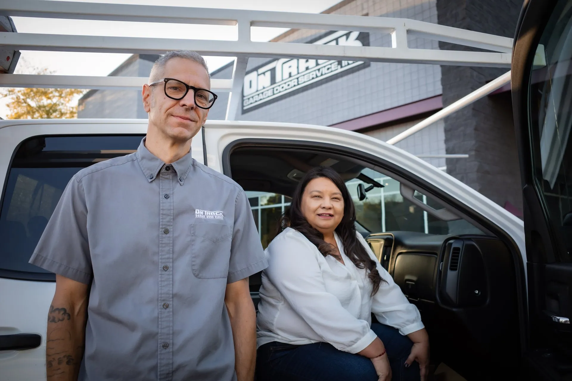 On Track couple owners with service truck